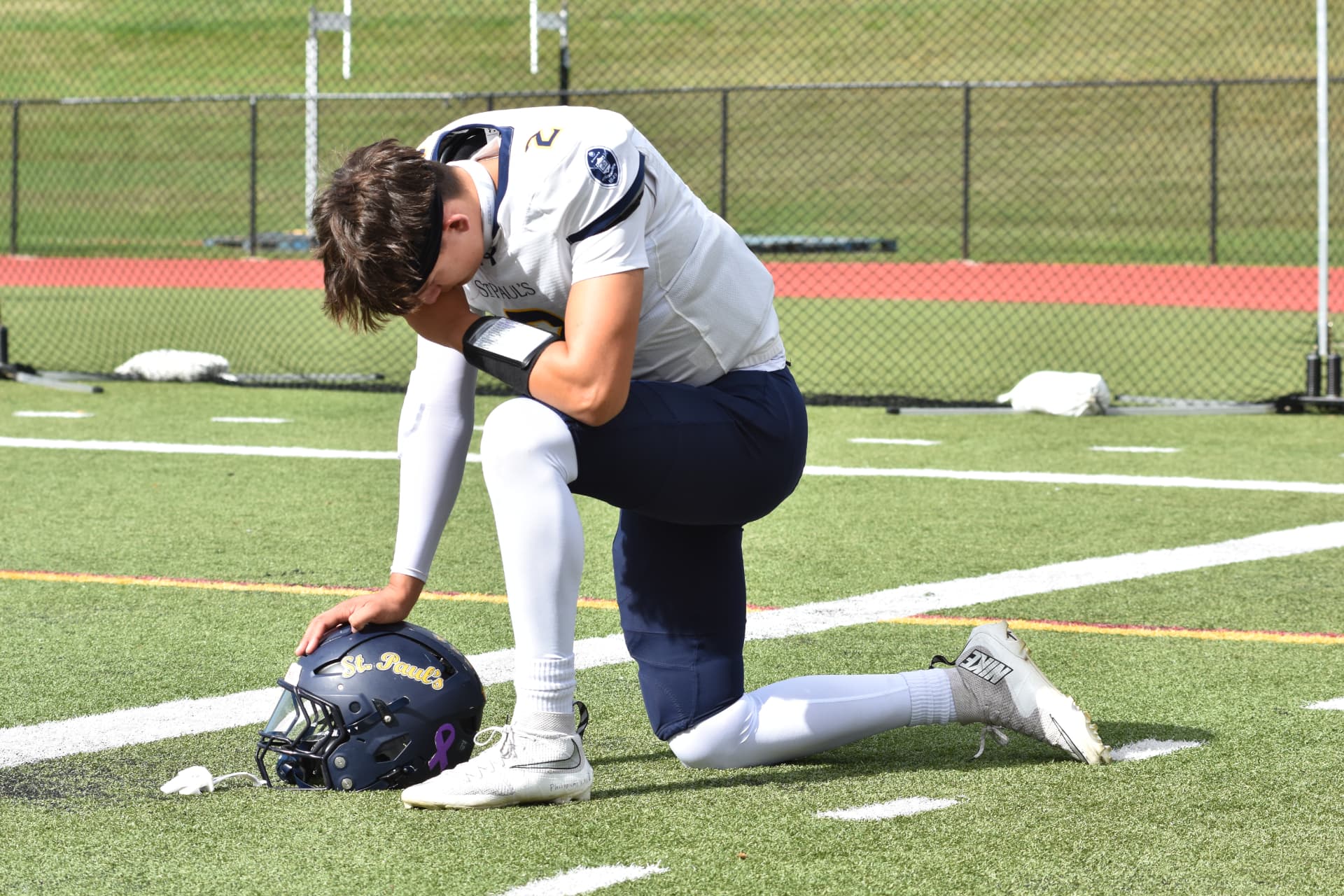 A Crusader catches his breath kneeling on the turf