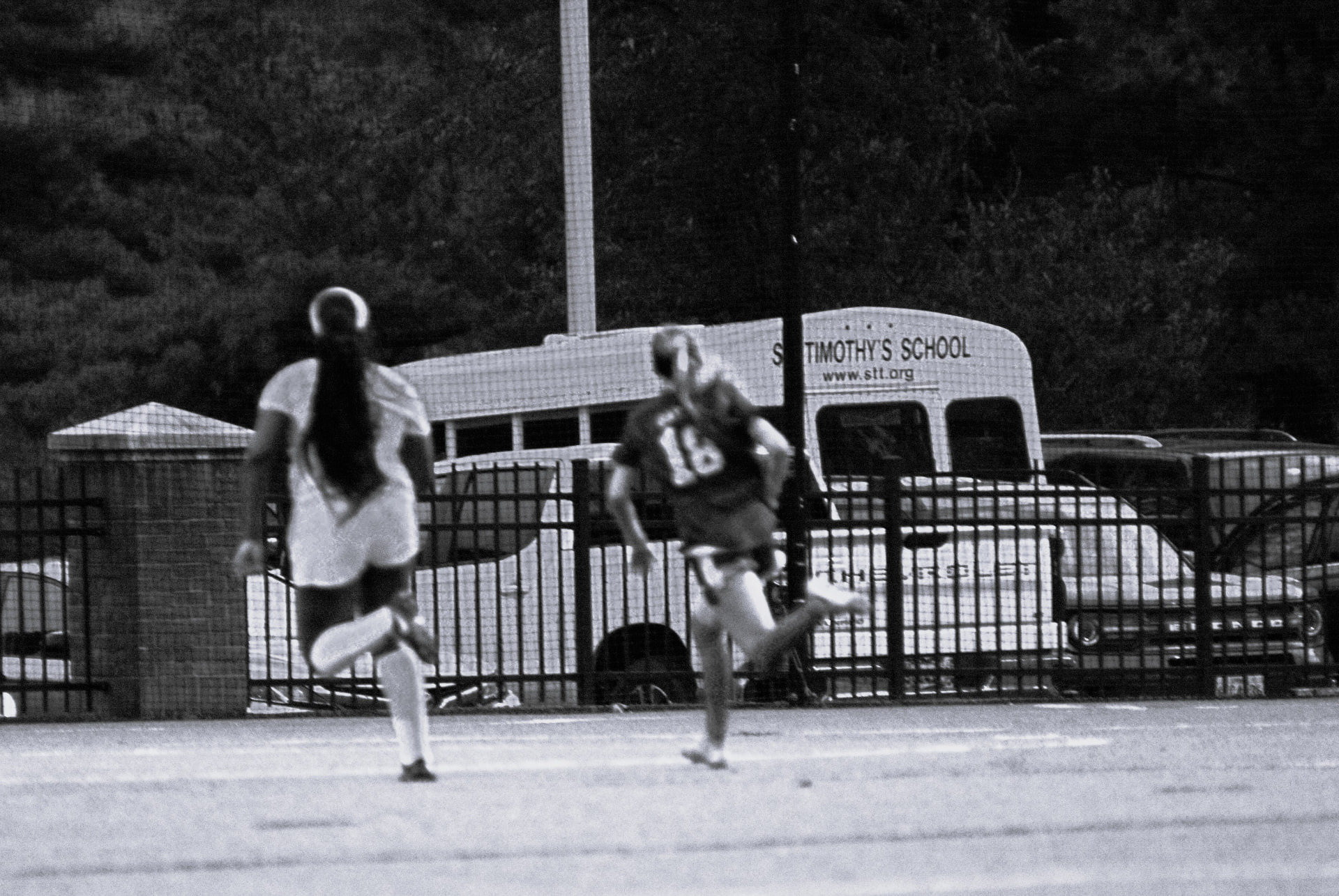 Gators number 16 chases play past the St. Timothy's bus