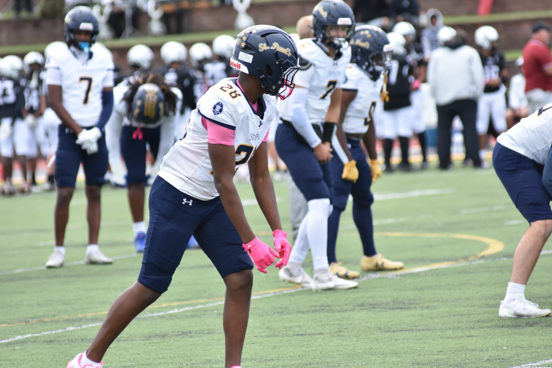 Crusaders number 25 in pink gloves settles into his stance during warmups