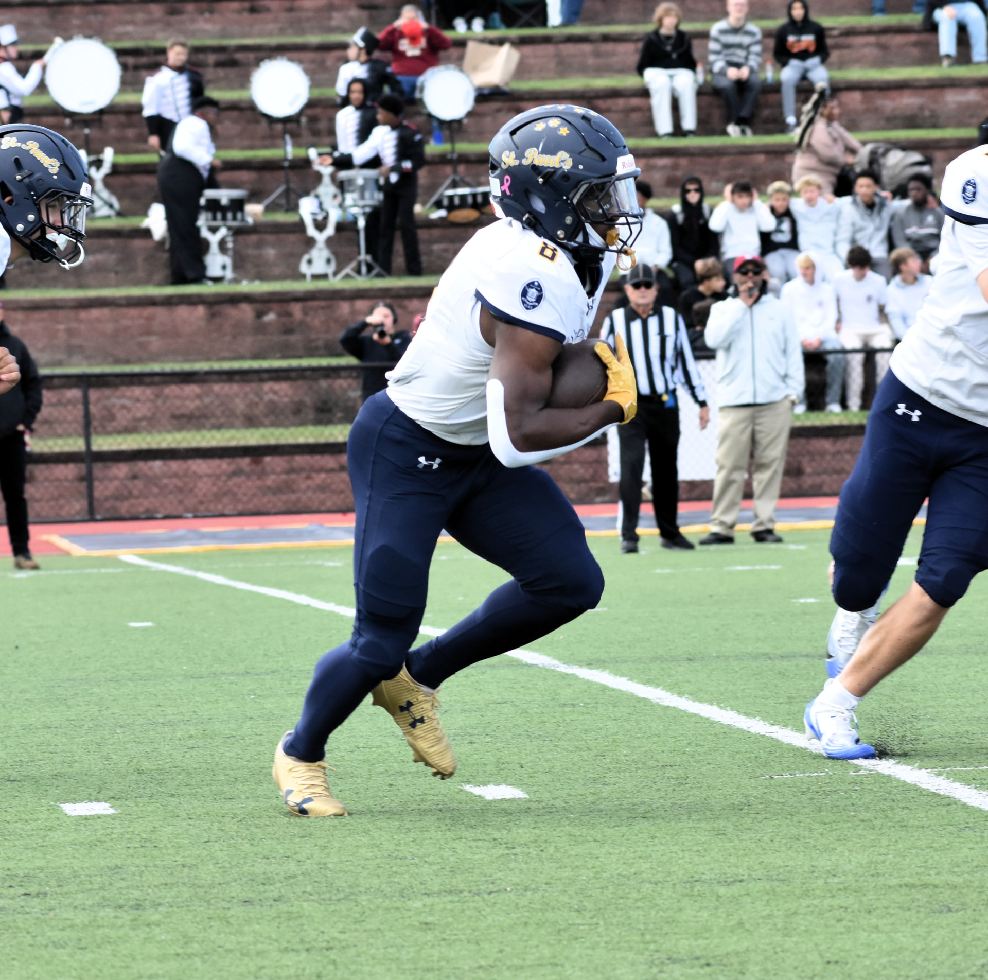 Crusaders number 6 turns upfield after a catch with the band behind