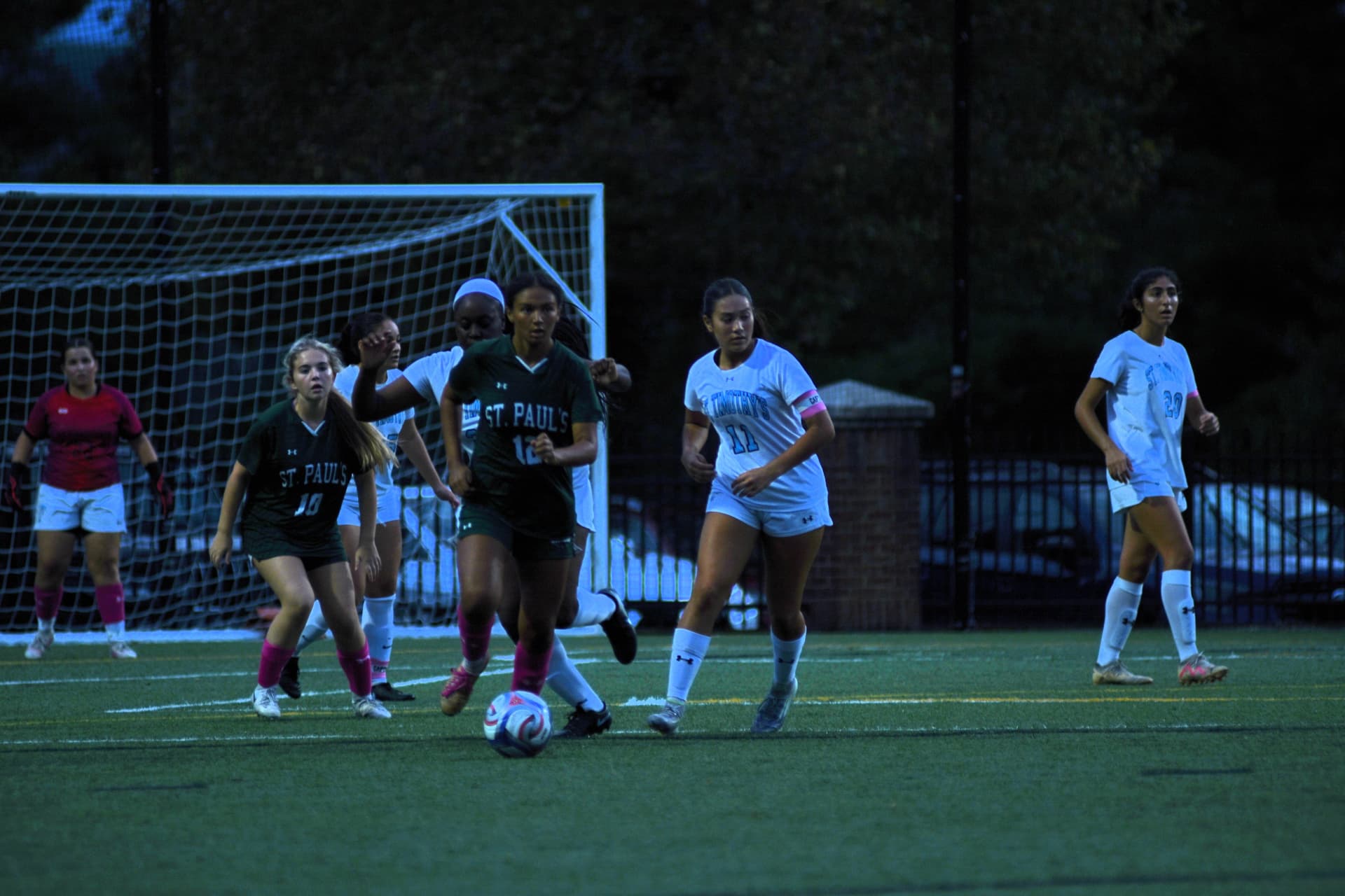 Gators number 12 dribbles out of traffic in front of the goal