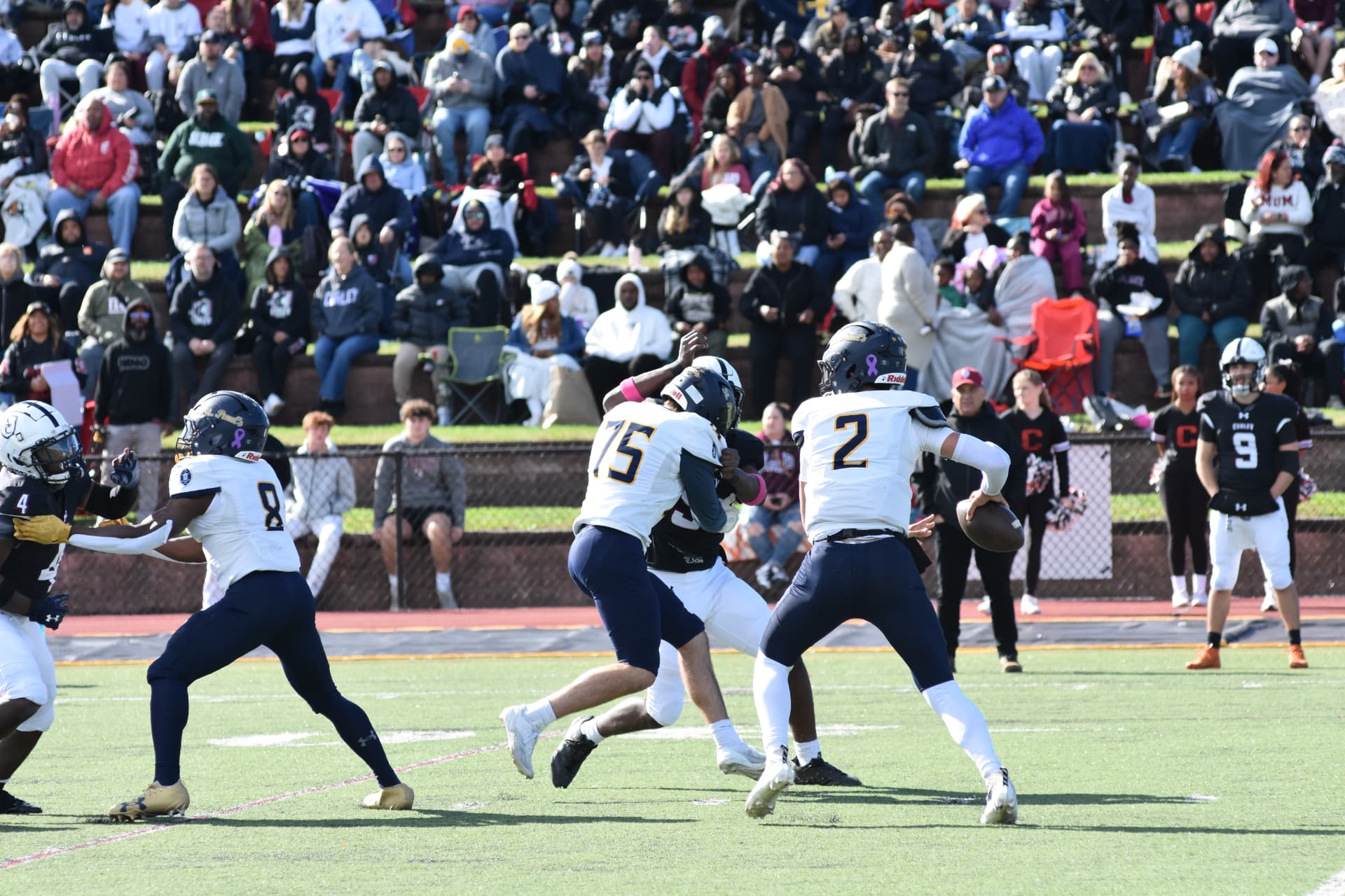 Crusaders quarterback number 2 prepares to pass behind his blockers