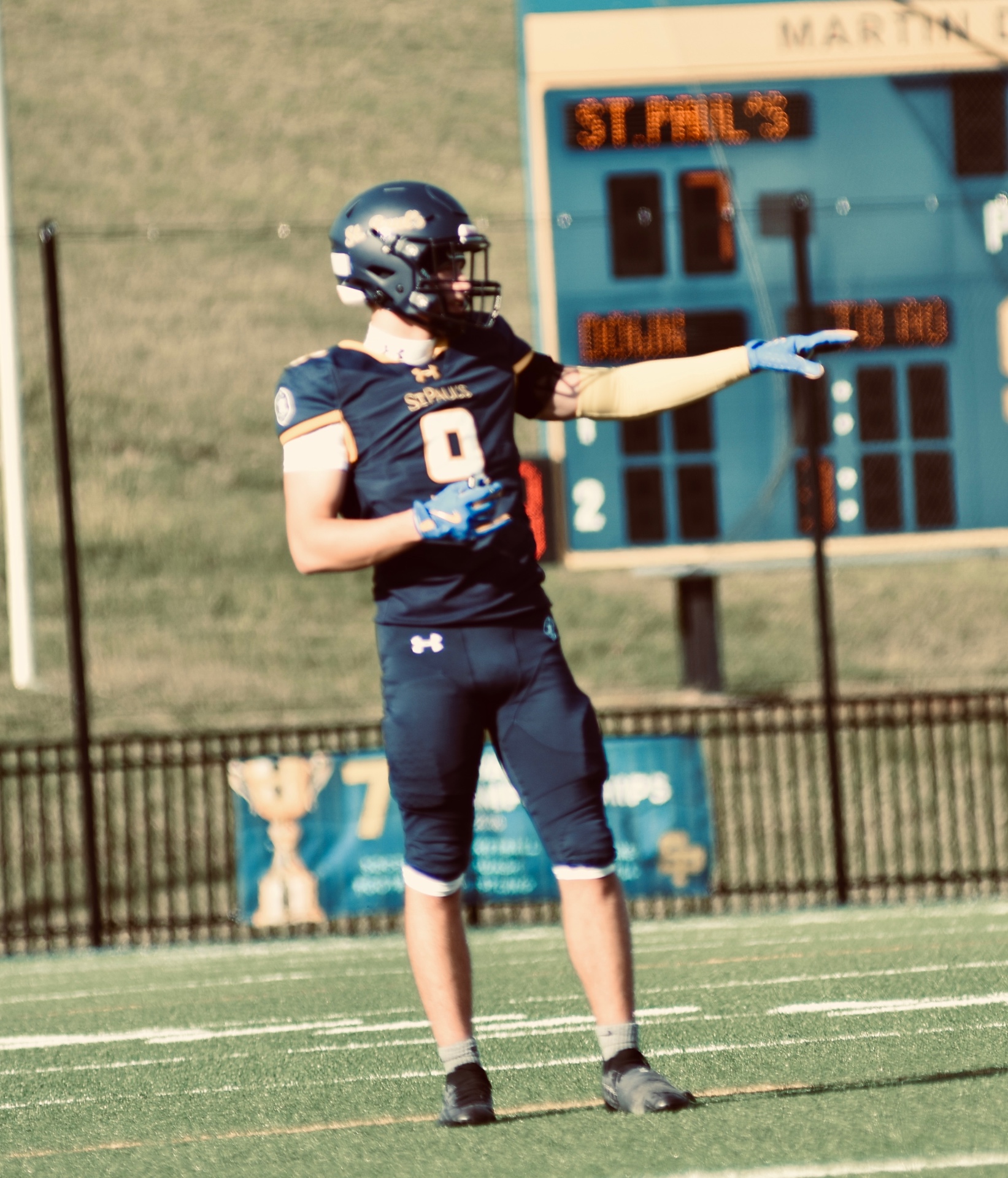 #9 pointing in front of the scoreboard