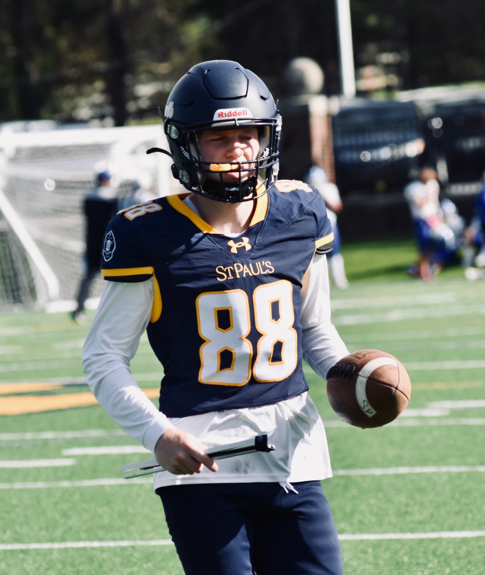 #88 carrying a football on the field