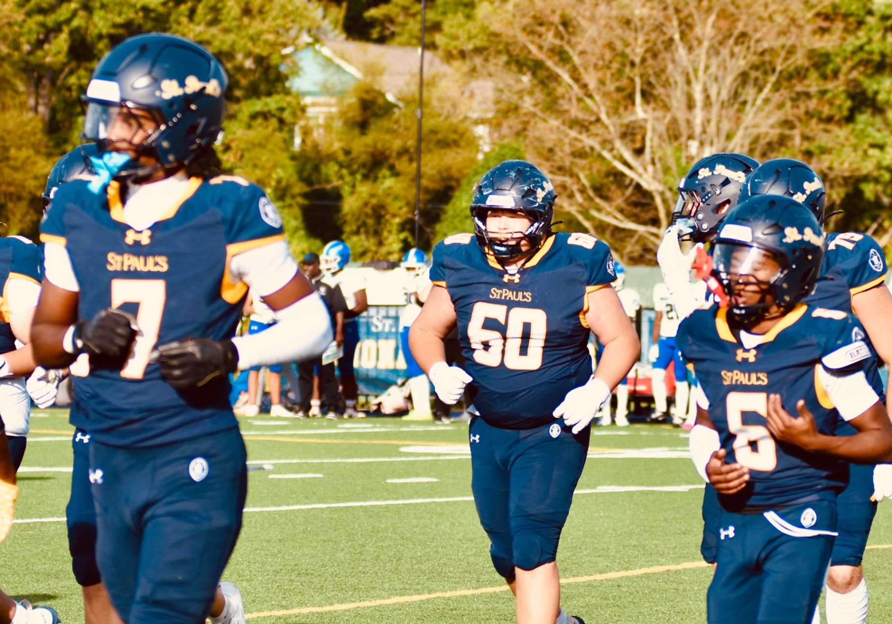 #60 and teammates between plays